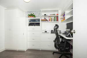 Office space with dark wood-style floors and built in study area