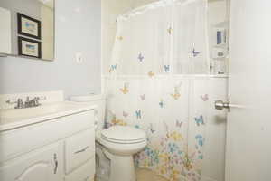 Bathroom featuring vanity, a shower with curtain, and light tile patterned flooring