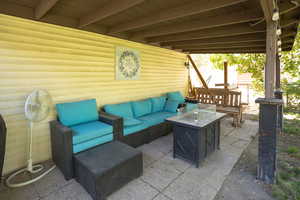 View of patio / terrace with an outdoor living space with a fire pit