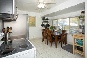 Dining area featuring light tile patterned floors and a ceiling fan