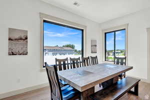 Dining area with light wood finished floors and baseboards