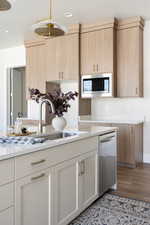 Kitchen featuring stainless steel appliances, dark wood-style floors, light stone countertops, and recessed lighting