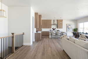 Living room with light wood finished floors and recessed lighting