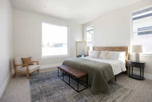 Carpeted bedroom featuring baseboards