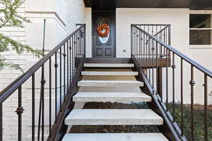 Entrance to property with brick siding