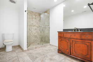 Bathroom featuring vanity, a stall shower, and recessed lighting