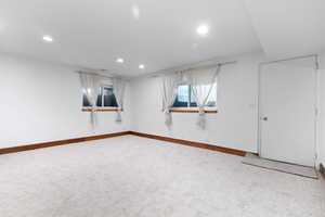 Unfurnished room with light carpet and recessed lighting