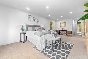 Bedroom with light colored carpet and recessed lighting