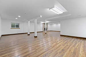 Basement with wood finished floors and baseboards