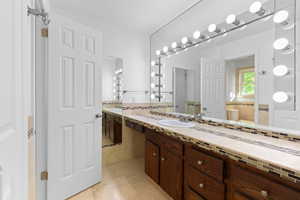Bathroom with vanity and light tile patterned floors