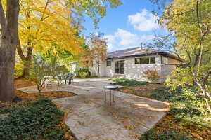 Rear view of property featuring a patio and brick siding