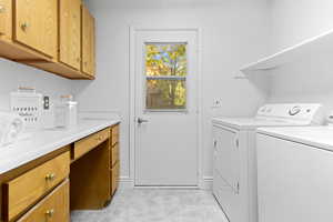 Laundry area with independent washer and dryer and baseboards