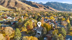View of mountain background with nearby suburban area and a tree filled landscape