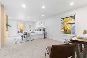 Bedroom with light carpet and recessed lighting