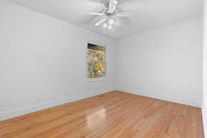 Unfurnished room with wood finished floors and ceiling fan