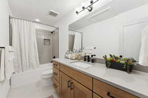 Full bath on the second level with quartz countertops, warm wood cabinetry accented beautifully with lovely tile and Moen bath fixtures.
