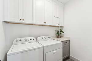 Washroom. Homeowner added additional custom cabinetry above the washer and dryer.