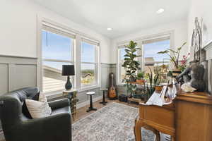 Den/office/music room/library accented with a wainscotting, recessed lighting, and custom blinds.