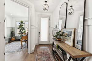 Entryway highlighting the double door entrance into the den/office area/music room/library room.