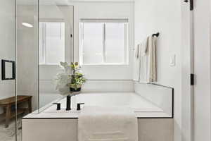 Full bath featuring a bath and tiled shower