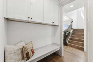 Mudroom accented with a bench and additional custom cabinetry added by the homeowner.