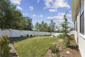 View of fully fenced backyard.