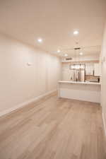 Unfurnished living room featuring recessed lighting and light wood finished floors