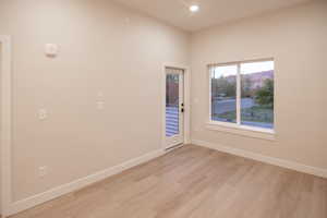 Spare room with light wood-style floors and recessed lighting