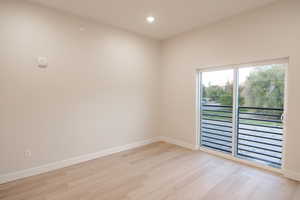 Empty room featuring light wood-style floors and recessed lighting
