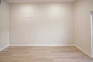 Empty room featuring light wood-type flooring and baseboards