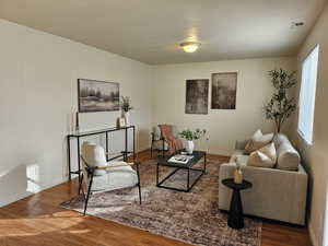 Living area with wood finished floors and a textured ceiling