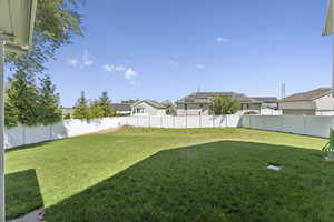 Fenced backyard with a residential view