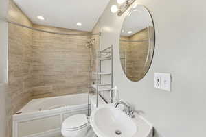 Full bath featuring shower / bath combination and a sink