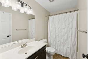 Bathroom with vanity, tile patterned flooring, and shower / tub combo