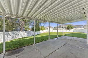 Fenced backyard featuring a patio area and a residential view