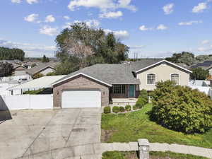 View of front of property with a garage, driveway, brick siding, and a shingled roof