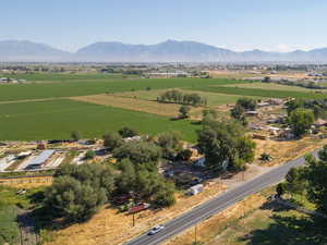View of rural area featuring a mountain backdrop and abundant farmland