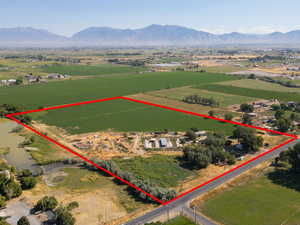 Aerial view of sparsely populated area with property boundaries highlighted and mountains