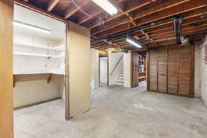 Unfinished below grade area featuring stairs