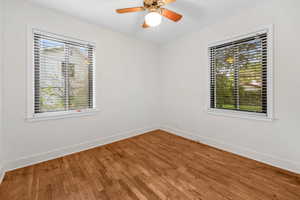 Empty room featuring wood finished floors and ceiling fan