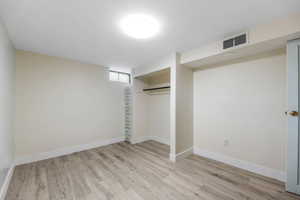 Unfurnished bedroom with light wood-style flooring and a closet