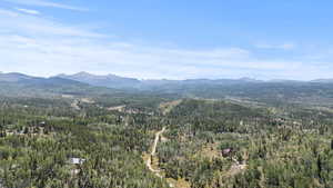 View of mountain backdrop featuring a heavily wooded area