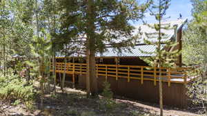 View of property exterior with a metal roof