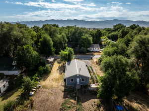View of subject property with mountains and a heavily wooded area