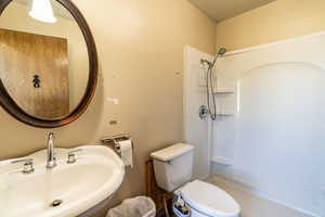 Full bathroom featuring a shower and a textured ceiling