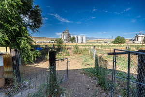 View of yard with a gate and a rural view