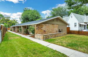 Back of house featuring stone siding