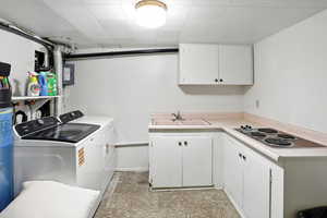 Laundry area featuring washer and clothes dryer and a sink