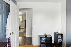 Bedroom featuring wood finished floors and baseboards