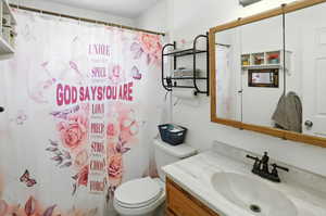 Bathroom with vanity and curtained shower
